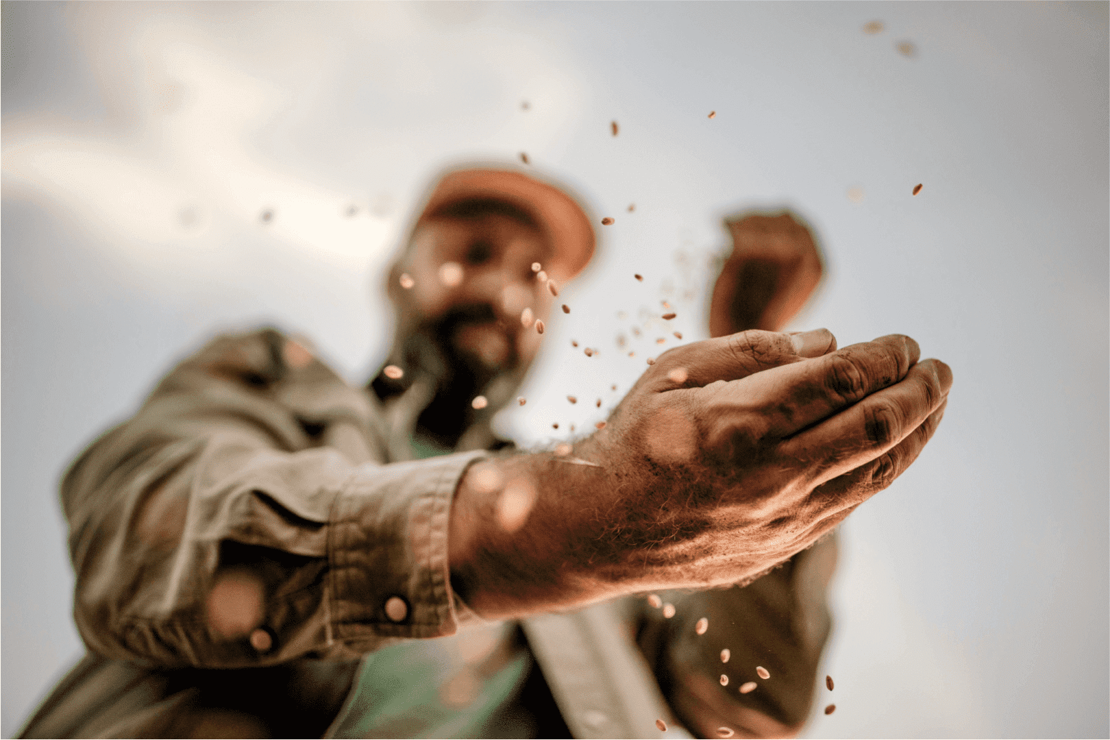 Man pouring grains over his hand