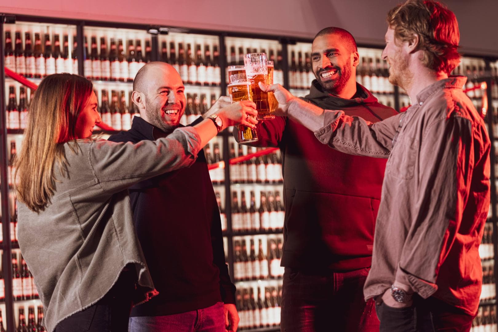 Group of people clinking their glasses of beer together